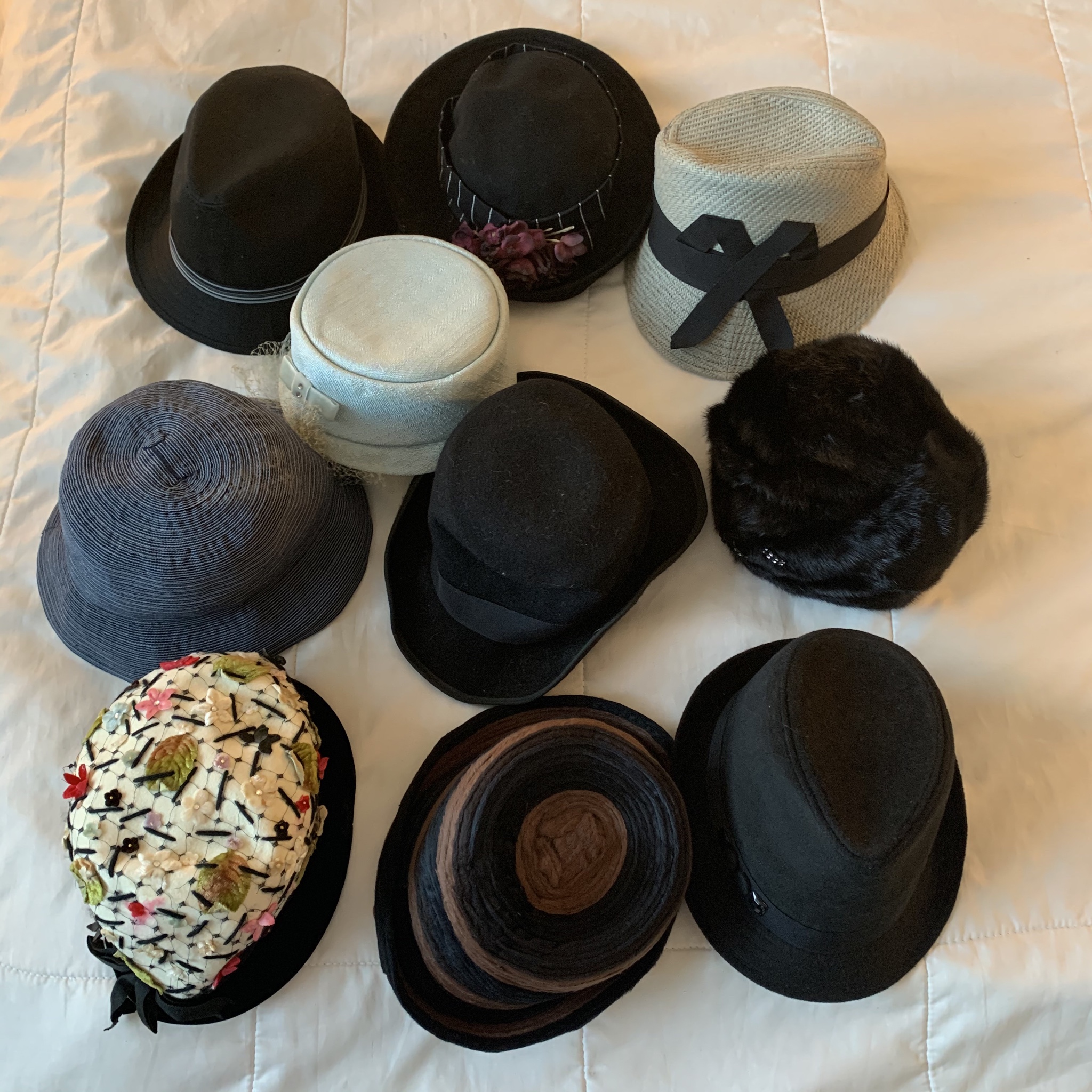 10 fun and fancy dress hats arranged neatly in a square.