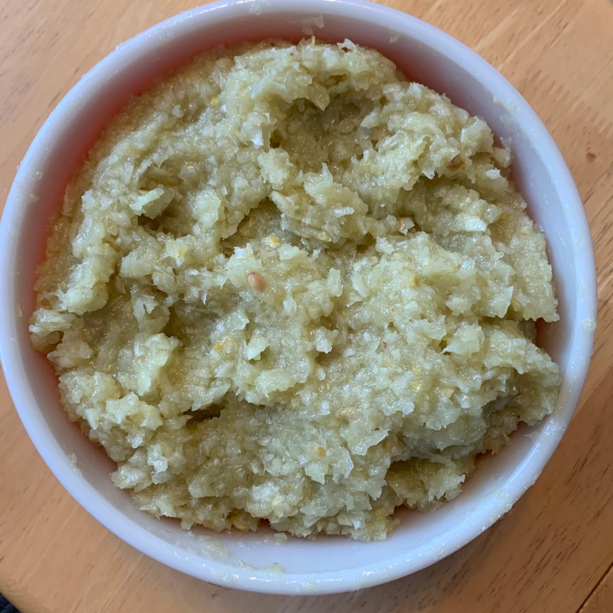 Aerial POV of lemon pulp whipped butter in a deli food storage tub.
